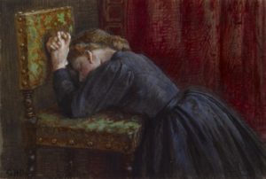 Woman kneeling in prayer